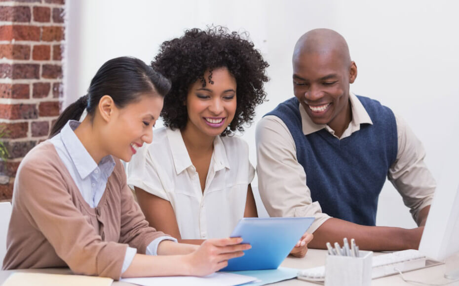 three people using a tablet