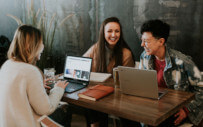 three people sitting around a table