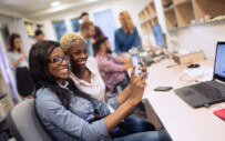 two people looking at a phone