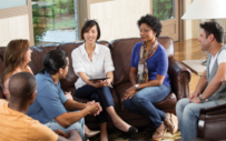 group of men and women sitting around talking