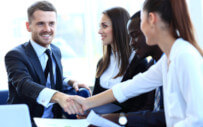 group of men and women shaking hands