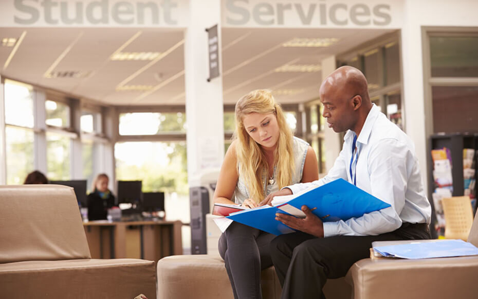 A student sits with her college mentor to go over her career readiness.