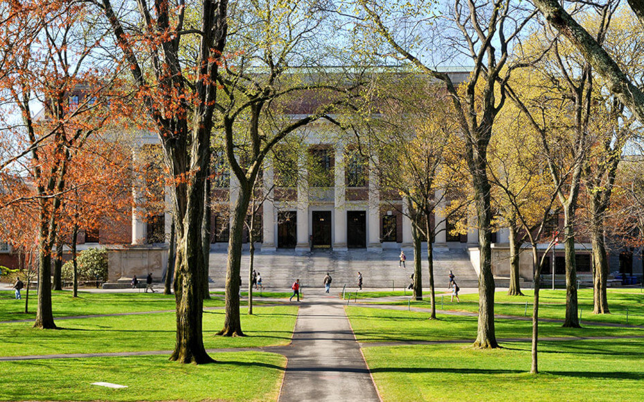 picture of college campus with a building and students off in the distance