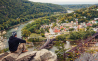 A rural student is sitting at an overlook.