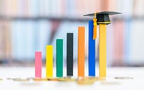 A set of blocks create a bar graph with a graduation cap atop the highest bar.