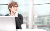 man sitting in front of a laptop thinking