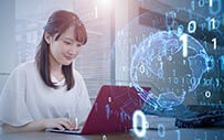 A student works on a laptop.