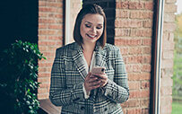 A young woman reviews a job offer on her cell phone