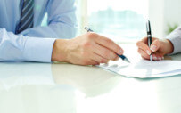 close up of two people working on a document