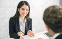 woman sitting across the table conversing