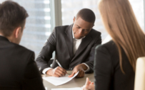 Employees signing noncompete agreements.