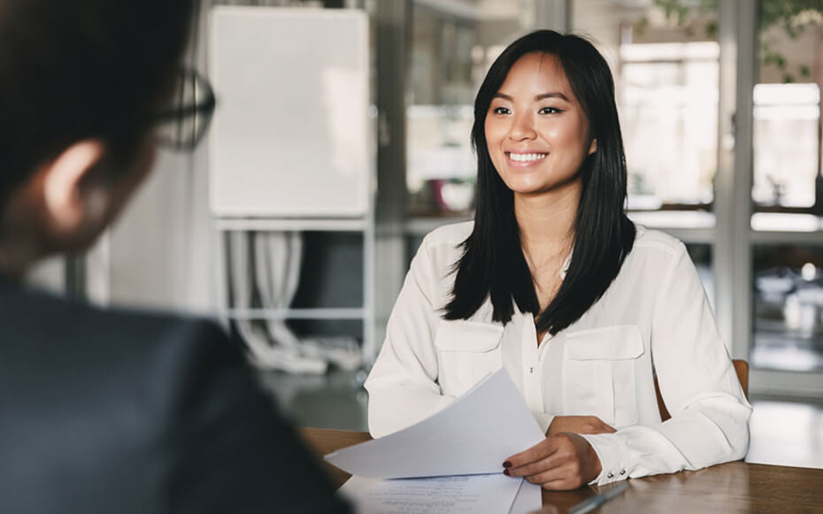 woman smiling across the table from interviewer