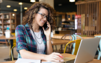 A young professional woman works remotely during a virtual internship.