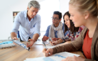 An employer works with a group of interns.