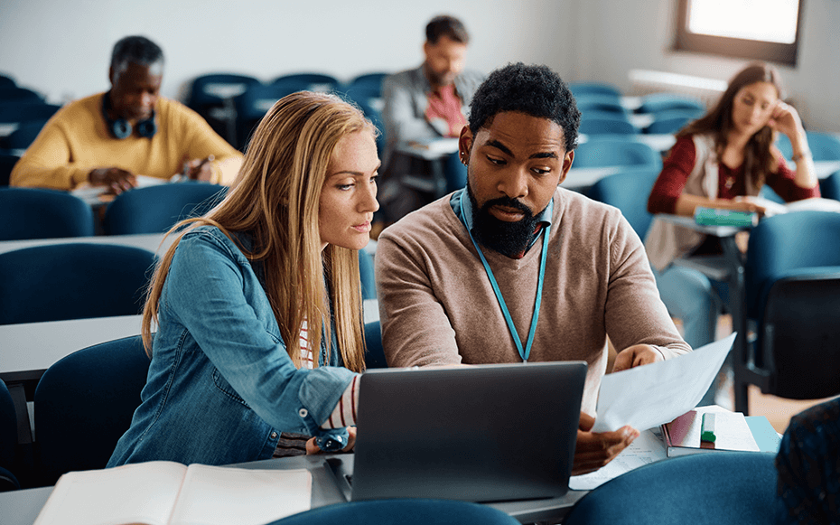 A faculty member speaks to a student.