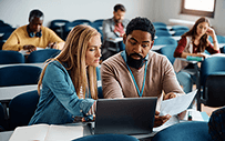 A faculty member speaks to a student.