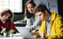 Person helping two students