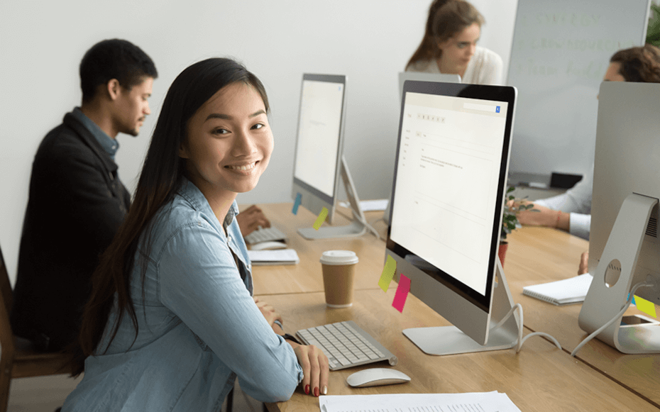 Interns sitting if front of a computer