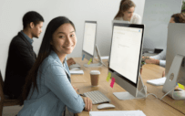 Interns sitting if front of a computer