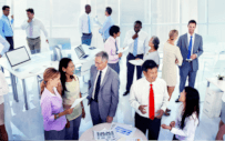 People standing around tables