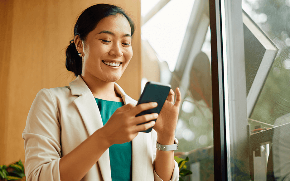 A woman enters data for a survey on her cellphone.